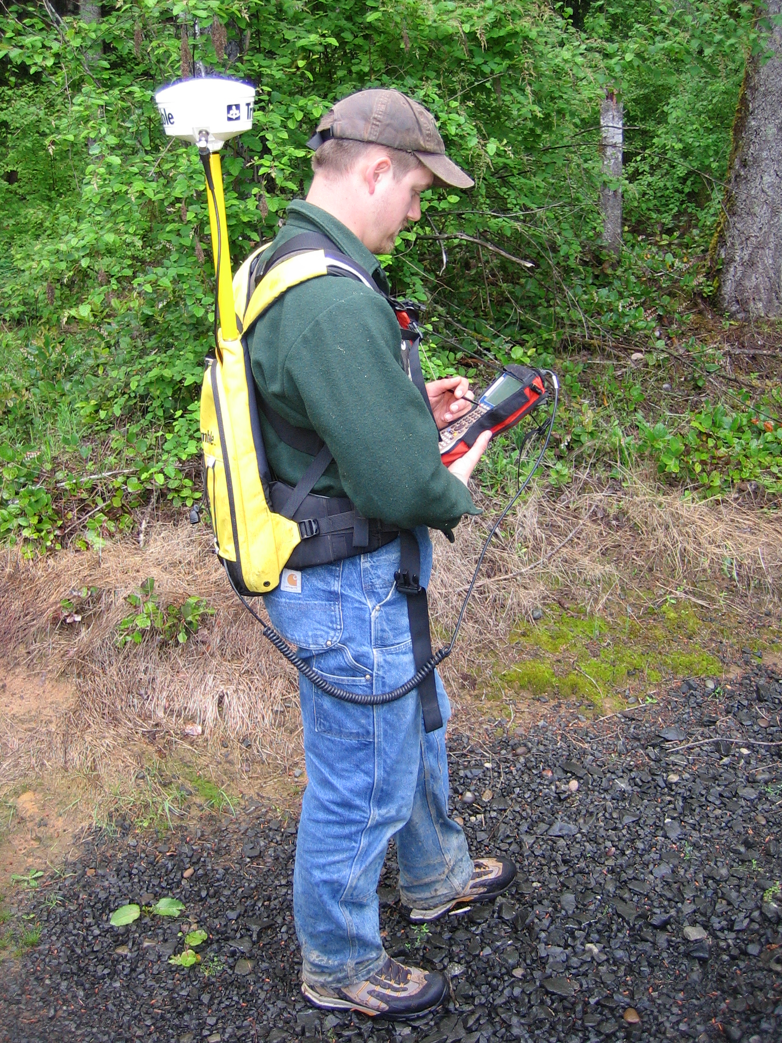 man with hand-held device doing GPS Data Collection