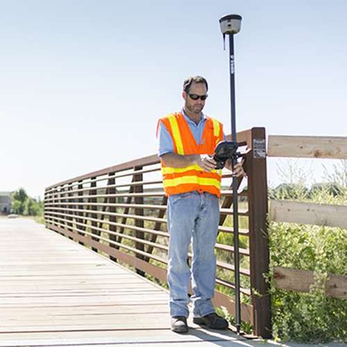 man with hand-held device doing GPS Data Collection