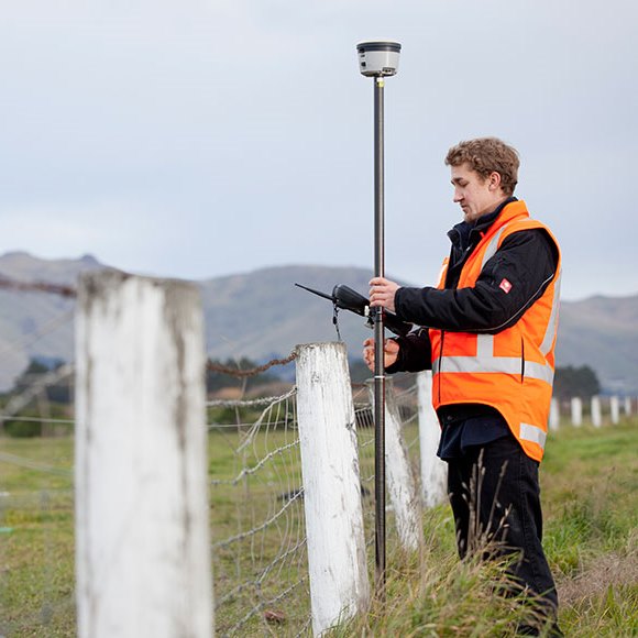 man with hand-held device doing GPS Data Collection