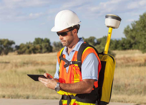 man with hand-held device doing GPS Data Collection